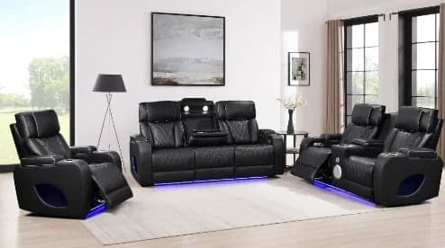 Modern living room with black leather reclining sofa set featuring LED lighting, placed on white rug with contemporary decor