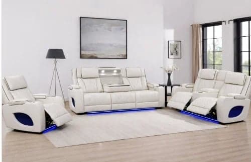 Modern living room with white leather reclining sofa set featuring blue LED accent lighting and matching armchairs on light wood flooring