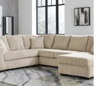 L180 Tate Ivory sectional sofa in beige with -16% discount, priced at $1,599.00 in living room setting