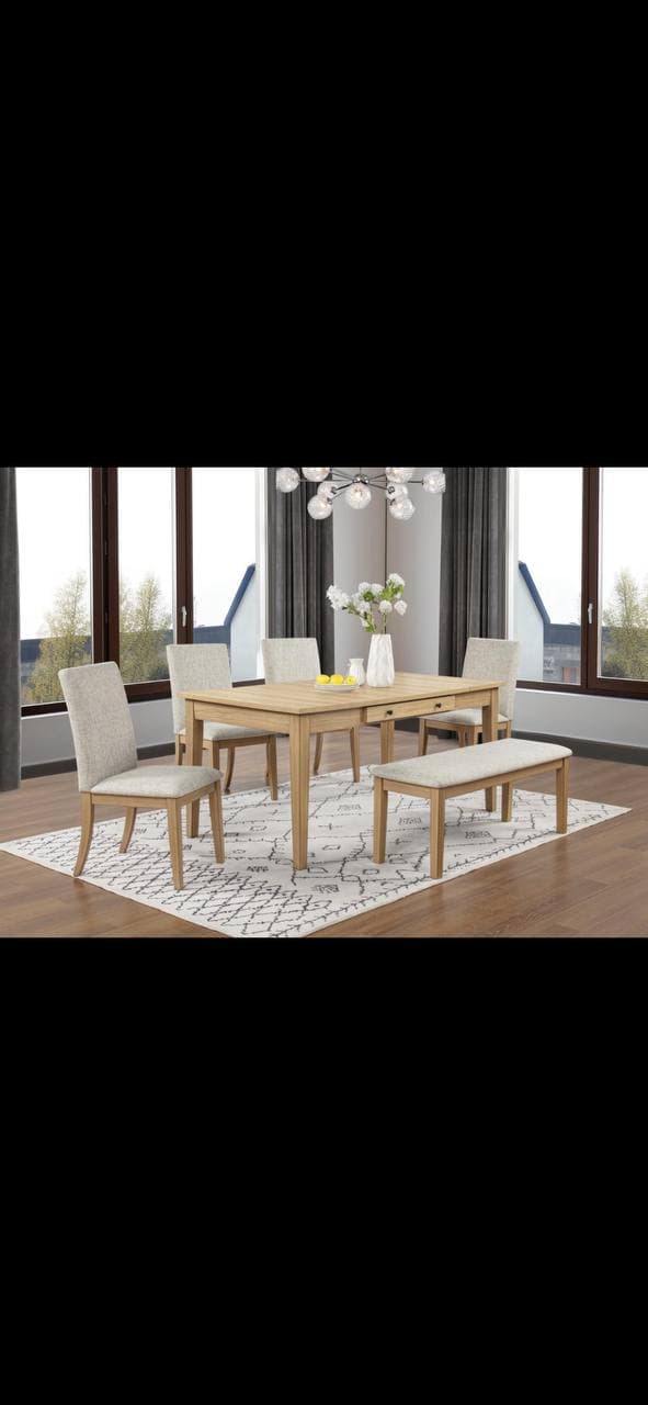Light oak dining table with beige upholstered chairs and matching bench in a bright dining room.